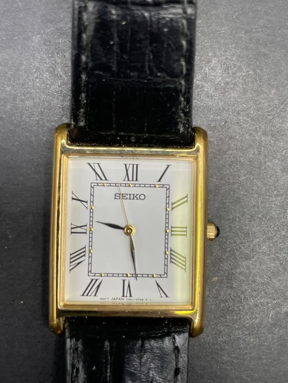 Seiko 7N01-0EZ0 Tank Rectangle Gold Tone Quartz Watch Black Leather Band 25MM